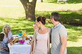 Couple with family dining at outdoor table