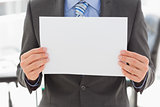 Businessman holding blank page