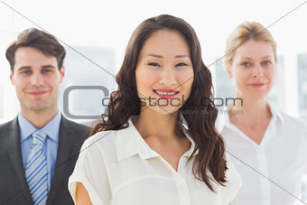 Happy businesswoman in front of her team
