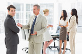Business people talking together in conference room