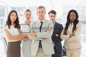 Business team looking at camera with arms crossed