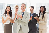 Business team standing and clapping