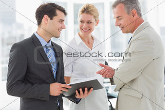 Smiling business team going over documents