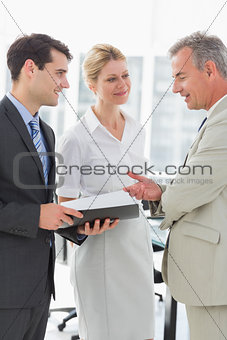 Smiling business colleagues talking together