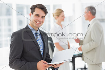Businessman reading over a document smiling at camera