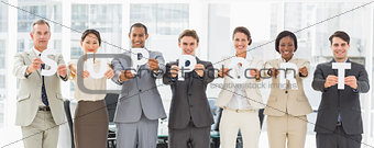 Diverse business team holding up letters spelling support