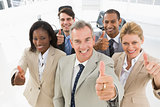 Diverse close business team smiling up at camera giving thumbs up
