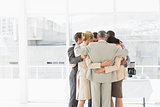 Business people hugging in a circle