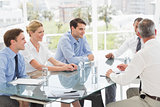 Smiling business people talking during a meeting