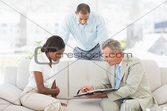 Salesman showing client where to sign the paperwork