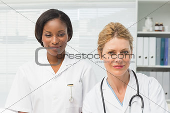 Happy doctor and nurse smiling at camera