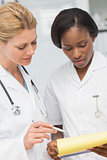 Doctor and nurse going over file together
