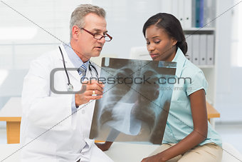 Doctor showing young patient her chest xray