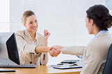 Women shaking hands in a business meeting