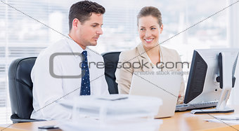 Smartly dressed colleagues using computer
