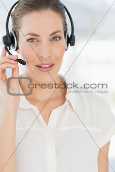 Closeup of a beautiful female executive with headset