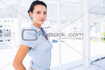 Serious young businesswoman in office