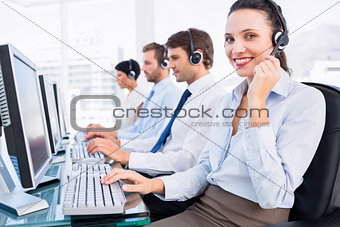 Business colleagues with headsets using computers