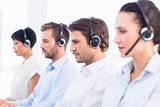 Group of business colleagues with headsets in a row