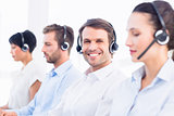 Business colleagues with headsets in a row