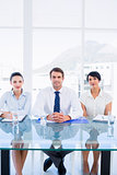 Smartly dressed young executives sitting at desk