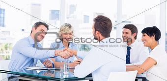 Executives shaking hands during business meeting