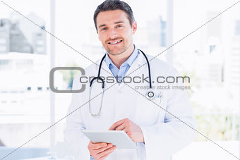 Portrait of a male doctor using digital tablet
