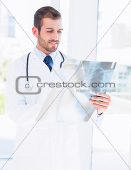 Male doctor examining xray in medical office