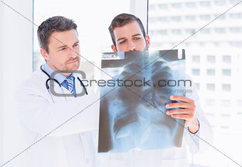 Male doctors examining xray in medical office