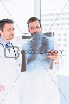 Male doctors examining xray in medical office