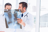 Two male doctors examining xray