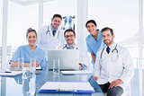 Happy medical team using laptop together