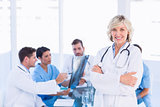 Smiling female doctor with colleagues in meeting