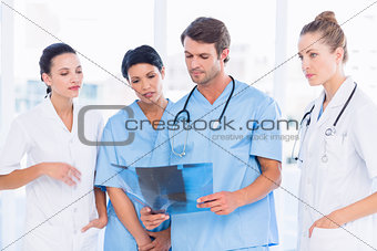 Group of doctors and surgeons examining xray