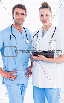 Male surgeon and female doctor with medical reports