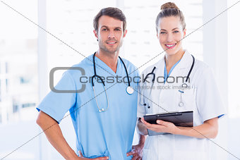 Male surgeon and female doctor with medical reports