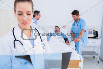 Doctor examining xray with surgeons and patient in hospital
