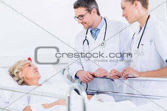 Doctors visiting a female patient in the hospital