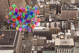 Many colourful balloons above city