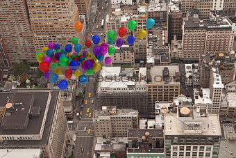 Many colourful balloons above city