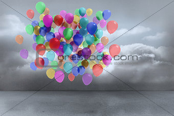 Many colourful balloons in cloudy room