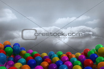 Many colourful balloons in cloudy room