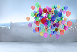Many colourful balloons in room with city on wall