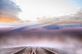 Train tracks leading to misty horizon
