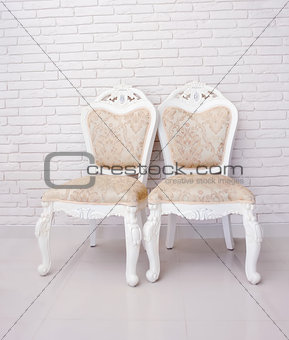 Two chairs against break wall