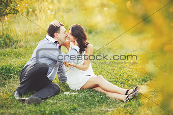 Caucasian young couple having date, spending great time in garden on summer sunny day.