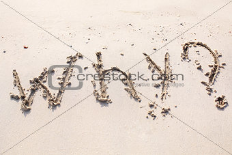 Words written on sand of Dubai beach.