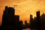industrial construction crane against sunset in Dubai city
