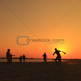 Football at Jumeira beach in Dubai during sunset.