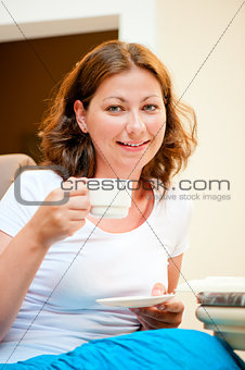 girl with a cup of coffee smiling